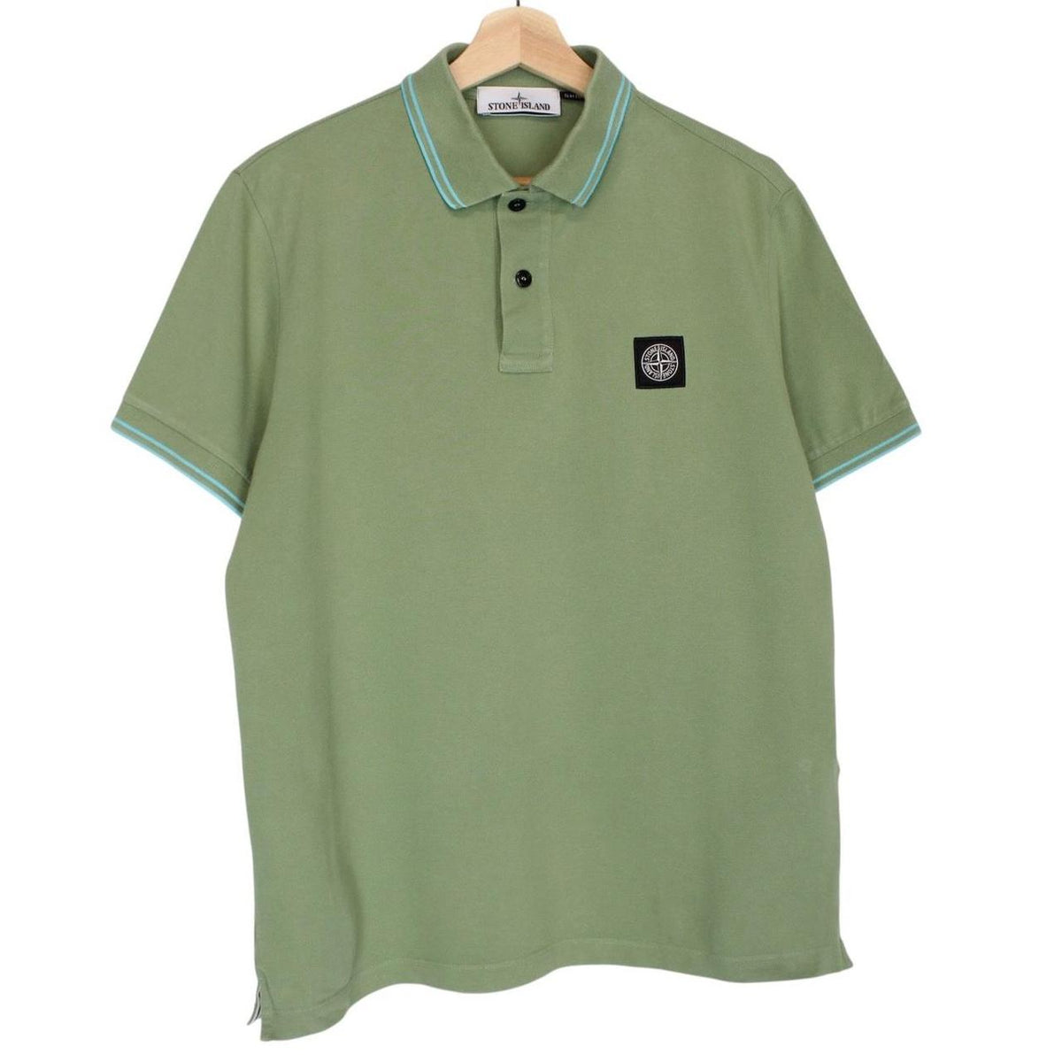 Stone Island green polo shirt with embroidered compass logo and cotton material.