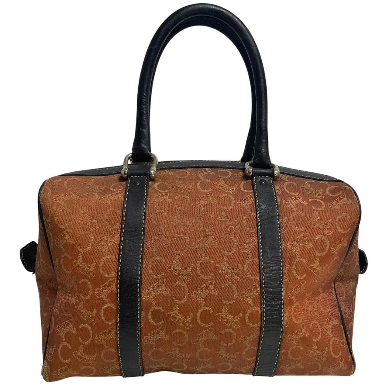 CELINE orange duffel bag with Macadam canvas and leather, visible wear and discolouration.