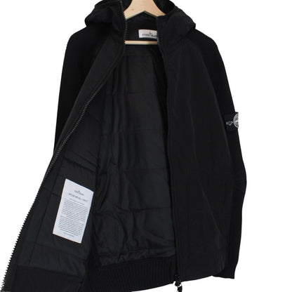 Stone Island black jacket with special process badge and full zip design.