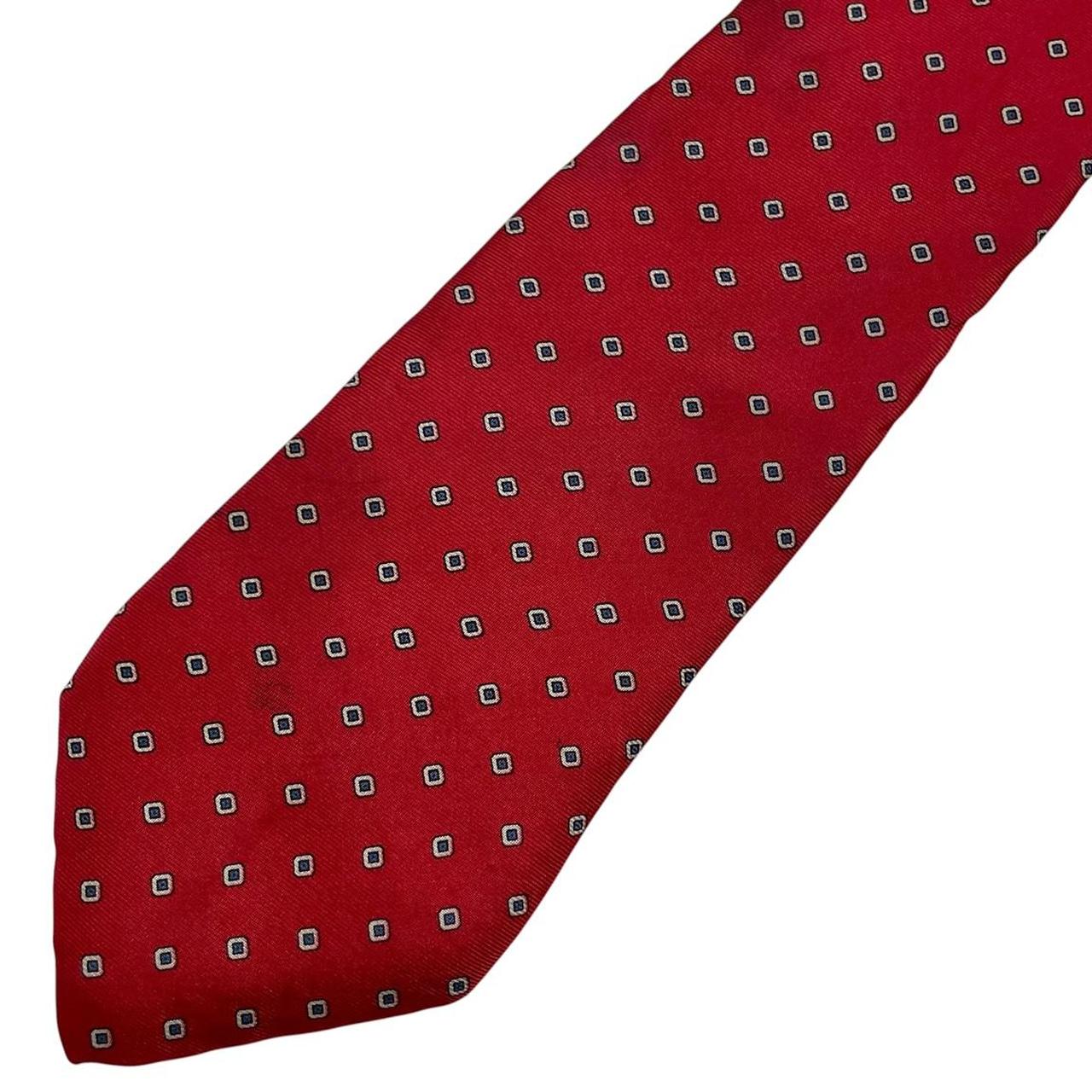 Yves Saint Laurent red silk tie with subtle sheen and vintage design.