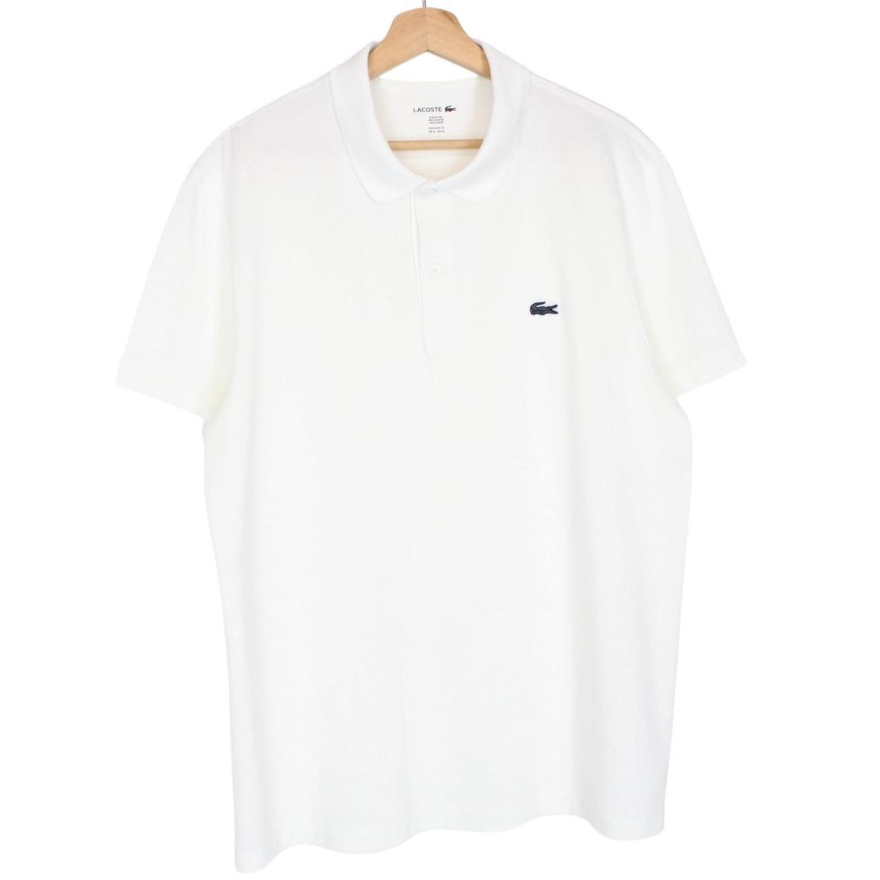 Lacoste white short sleeve polo shirt with green crocodile logo and cotton material.