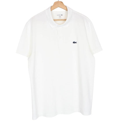 Lacoste white short sleeve polo shirt with green crocodile logo and cotton material.