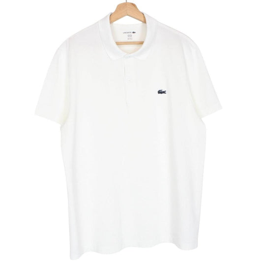 Lacoste white short sleeve polo shirt with green crocodile logo and cotton material.