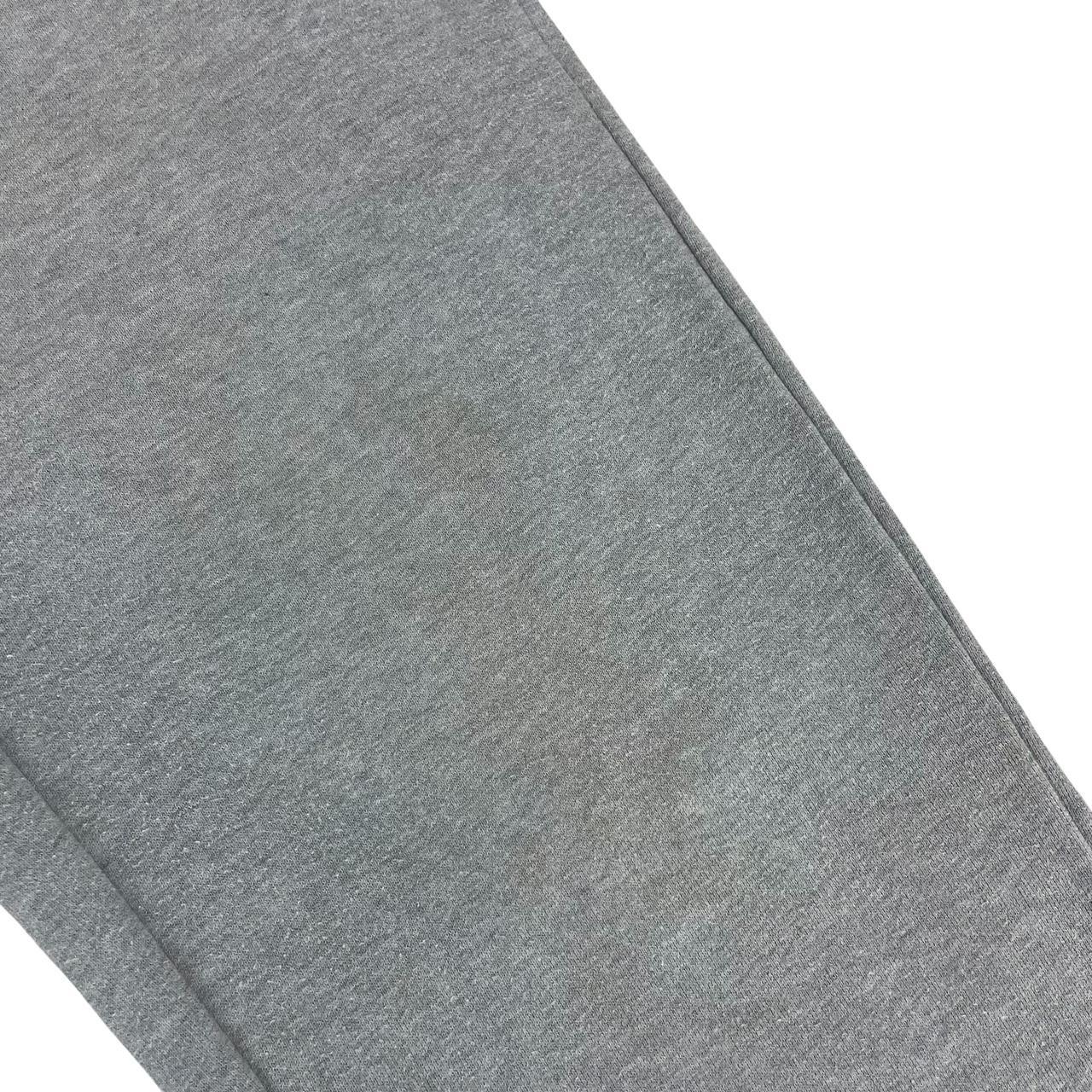 Stone Island grey tracksuit bottoms cotton material with logo patch and faint marks.