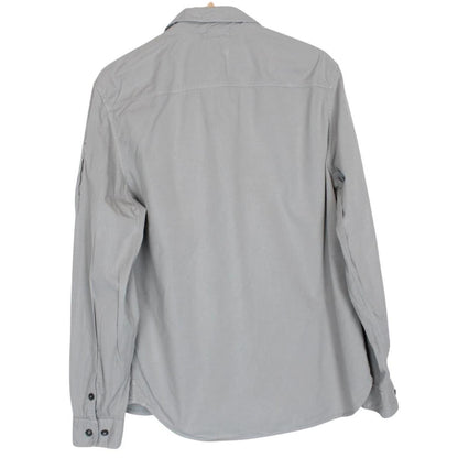CP Company grey full zip overshirt jacket with lens detail and cotton material.