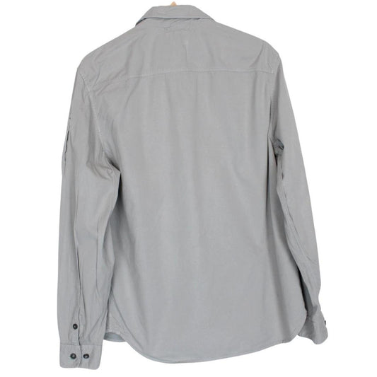 CP Company grey full zip overshirt jacket with lens detail and cotton material.