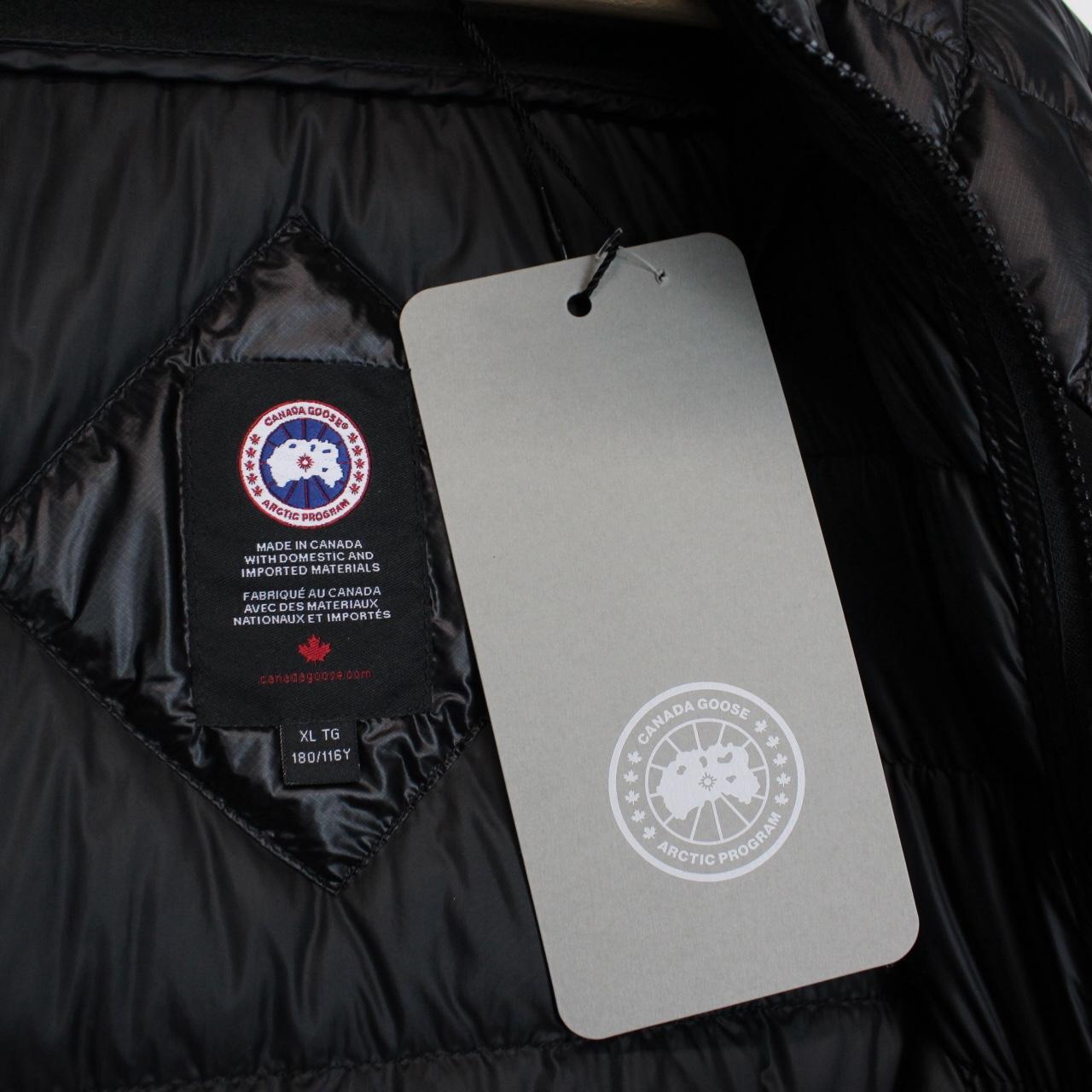 Canada Goose black down jacket with full zip and logo patch on sleeve.