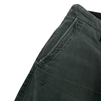 Stone Island green slim fit cotton trousers with logo patch and faded details.