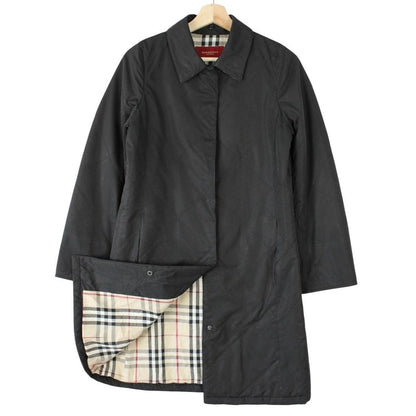 Burberry black trench coat featuring Nova Check pattern and quilted fabric.