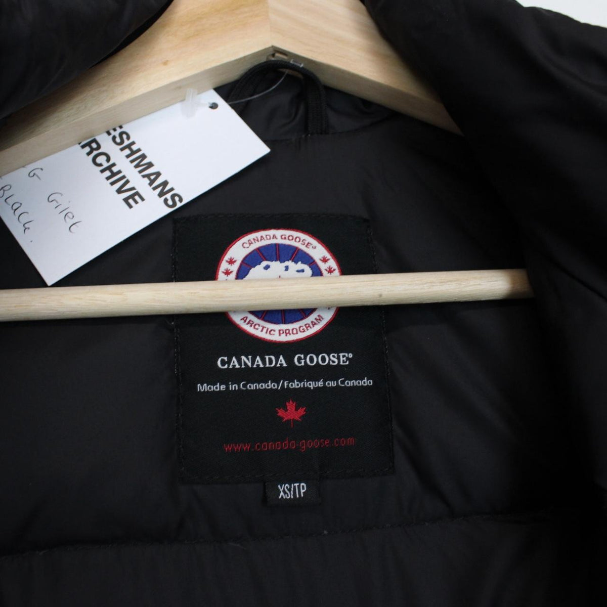 Canada Goose black down gilet with logo patch and durable exterior shell.