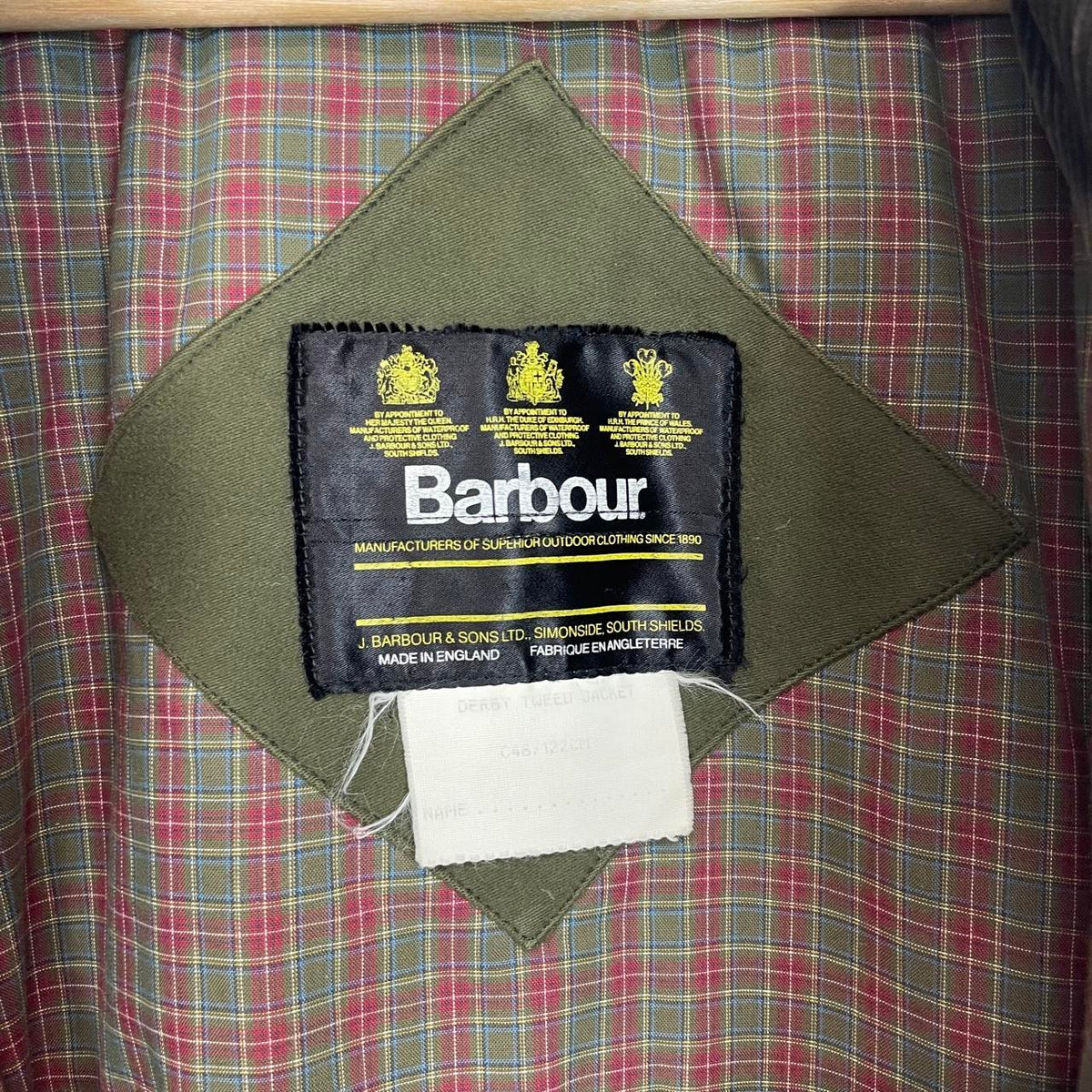 Barbour green tweed wool coat with classic pattern and missing front pocket button.