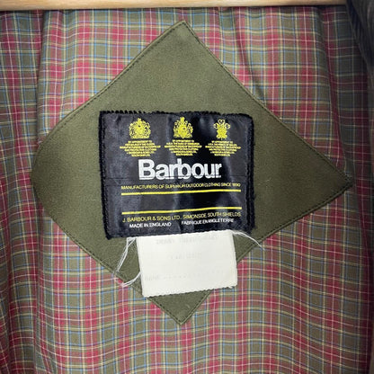 Barbour green tweed wool coat with classic pattern and missing front pocket button.