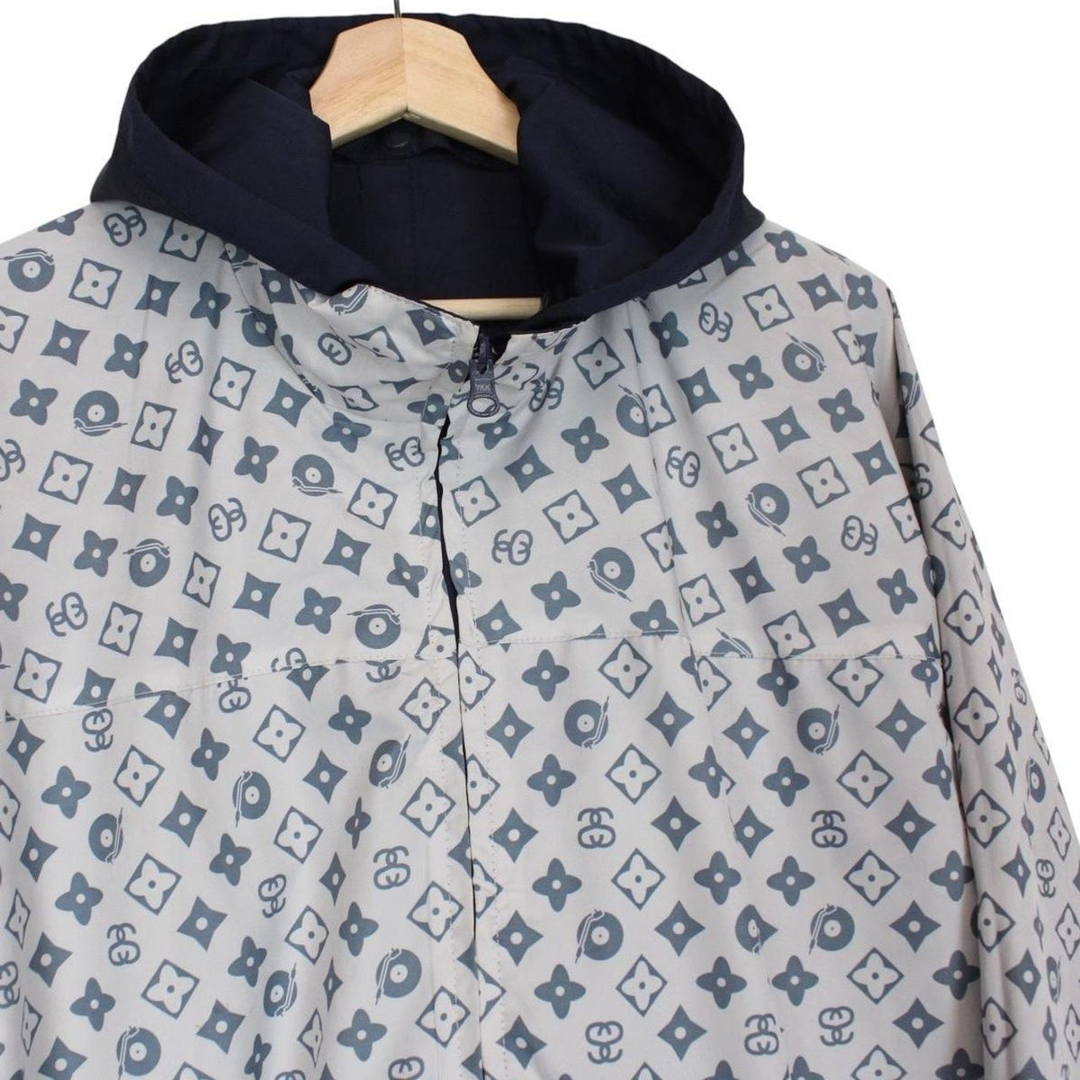 Stüssy reversible nylon jacket in grey and navy blue with logo detailing.