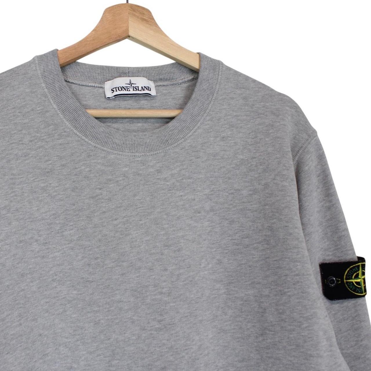 Stone Island grey cotton sweatshirt with logo patch and faint mark on sleeve.