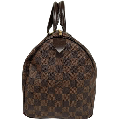 Louis Vuitton brown Damier Ebene canvas handbag with gold hardware and padlock detail.