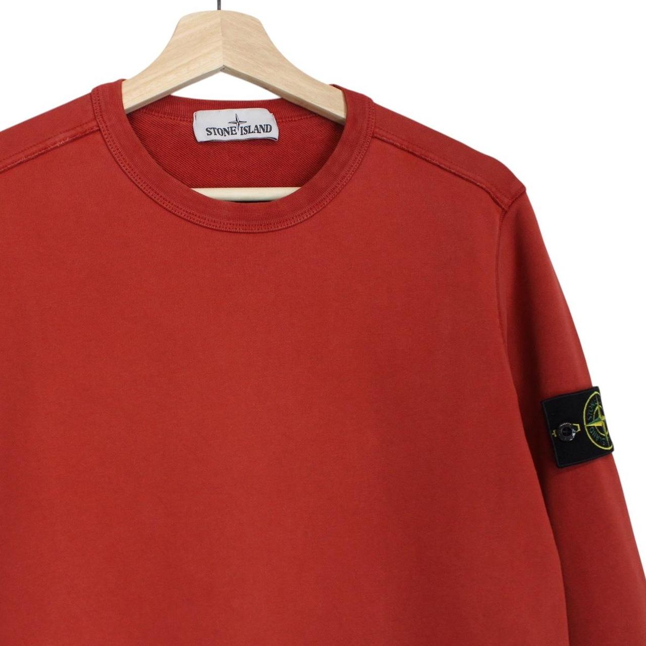 Stone Island red cotton sweatshirt with logo badge and ribbed cuffs.