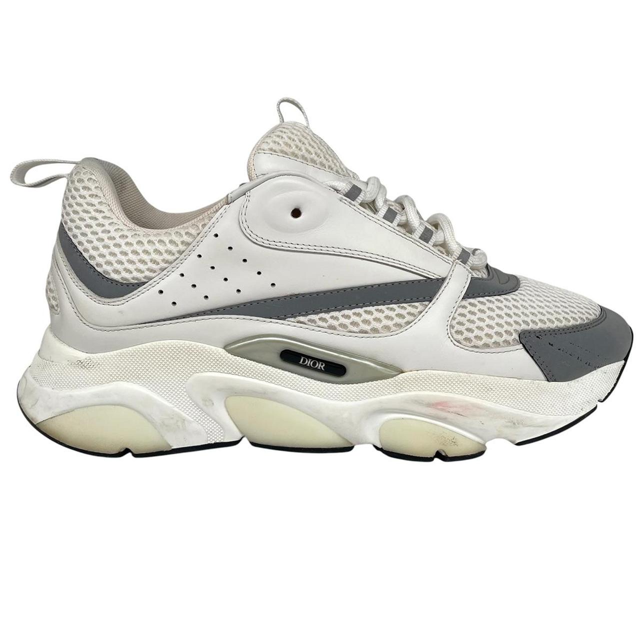 Dior grey and white trainers with logo detailing and worn soles.