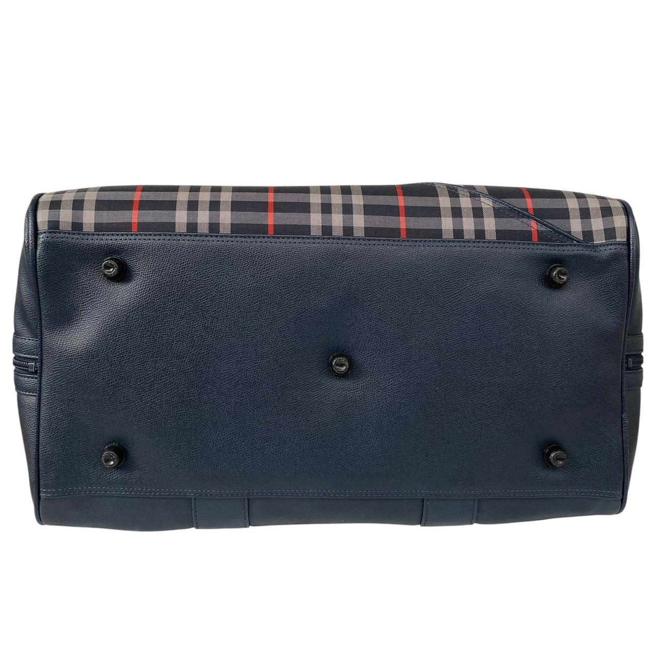 Burberry navy blue duffel bag featuring iconic Nova Check pattern and leather accents.