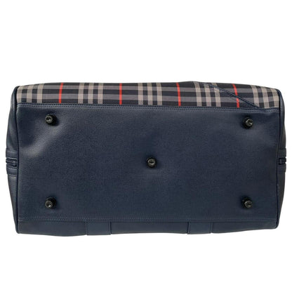 Burberry navy blue duffel bag featuring iconic Nova Check pattern and leather accents.