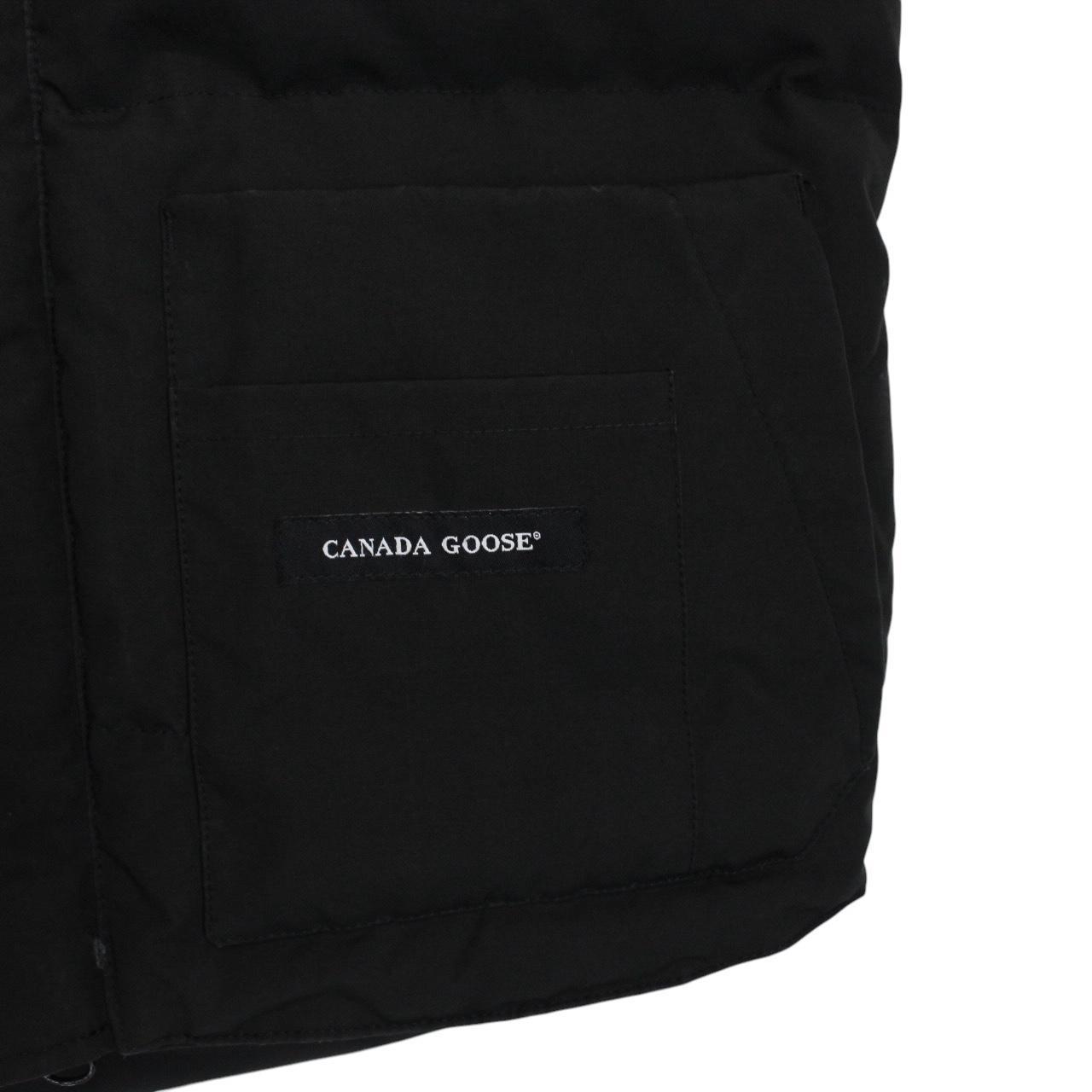 Canada Goose black down gilet with logo patch and zippered pockets.