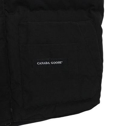 Canada Goose black down gilet with logo patch and zippered pockets.