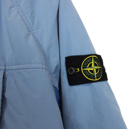 Stone Island blue jacket with logo patch and micropile texture, size small.
