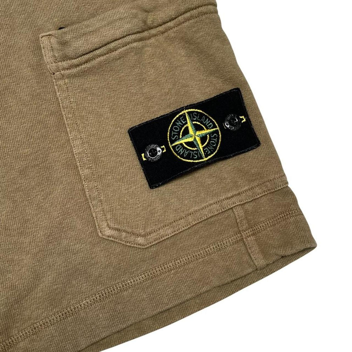 Stone Island khaki brown jogger shorts with logo patch and cotton material.
