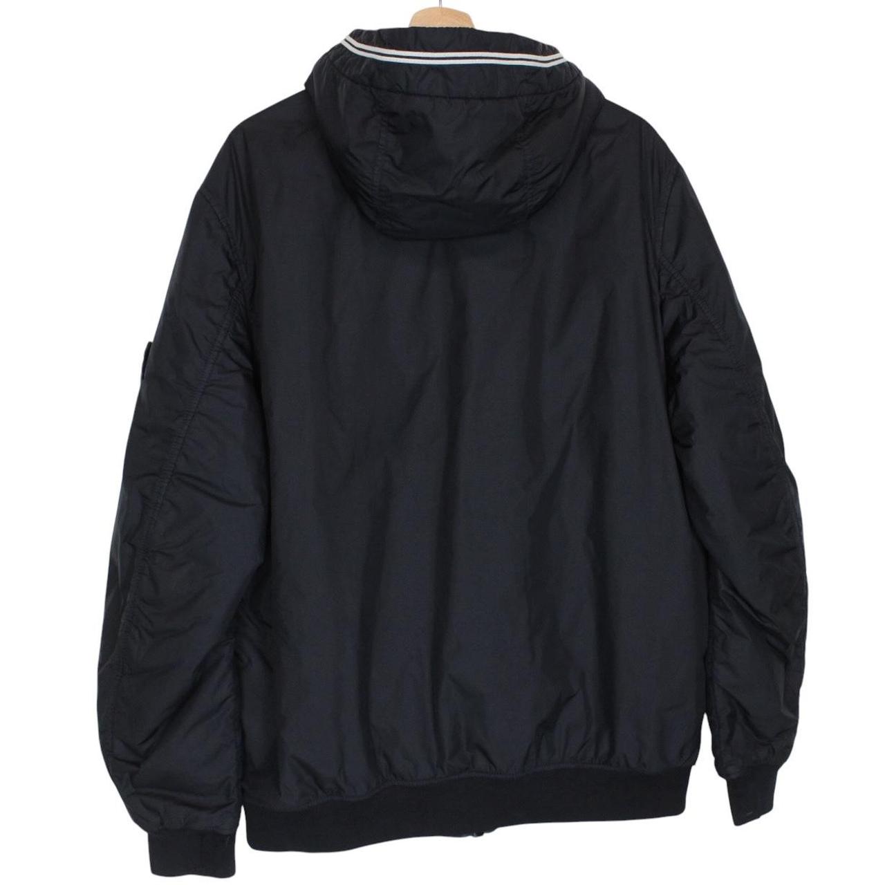 Stone Island black jacket with crinkle texture and logo patch on sleeve.