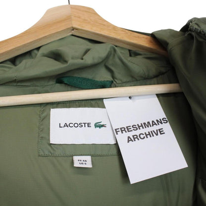 Lacoste khaki green bodywarmer full zip with signature crocodile logo and water-repellent material.