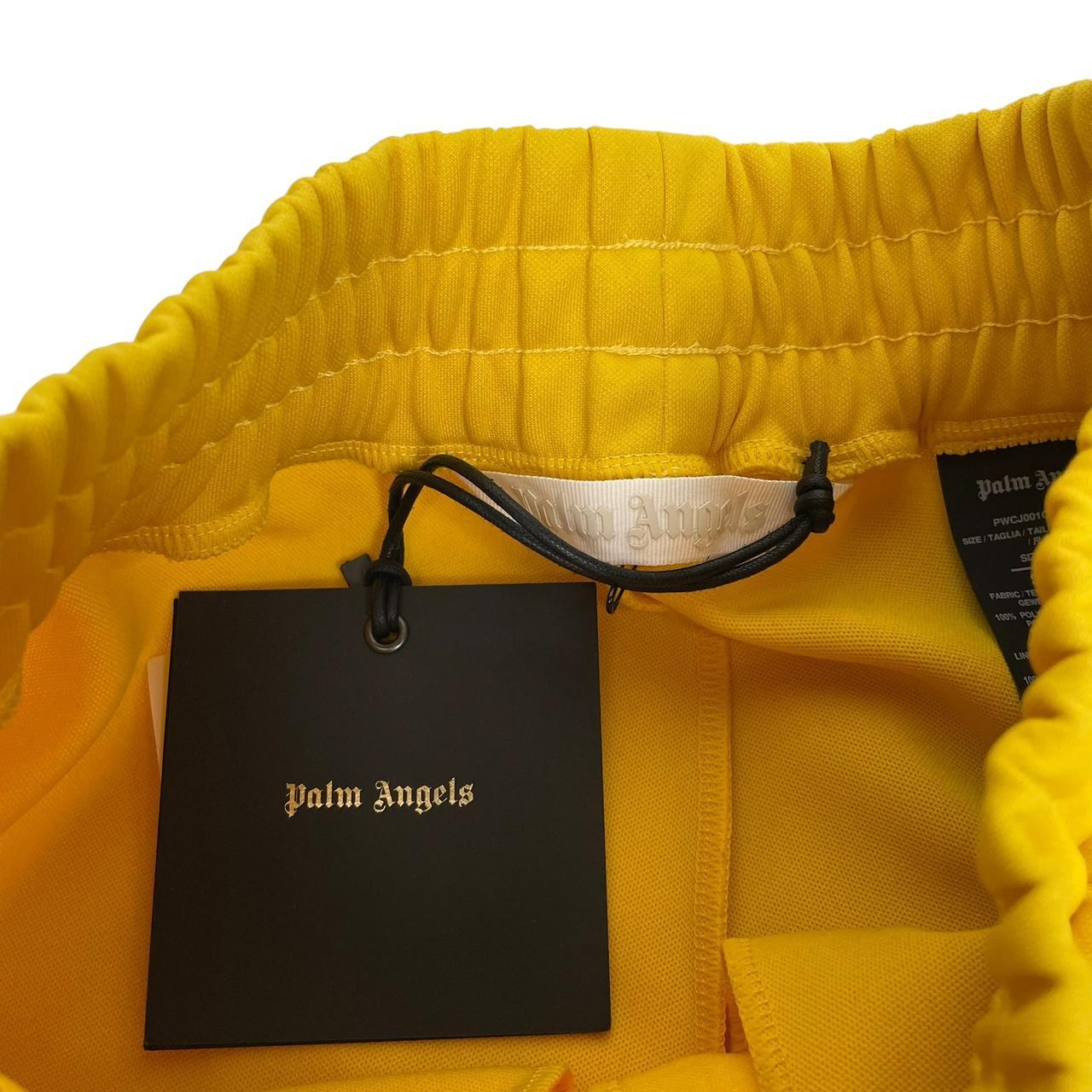 Palm Angels white and yellow joggers with logo detailing and classic fit.