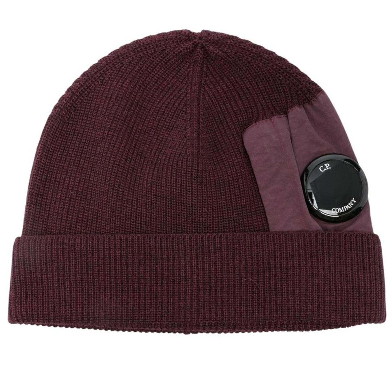 CP Company burgundy beanie hat extra fine merino wool with iconic lens detail.