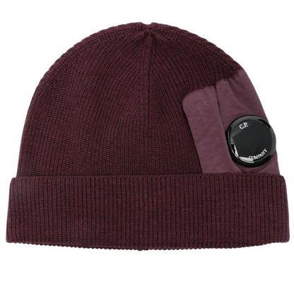 CP Company burgundy beanie hat extra fine merino wool with iconic lens detail.