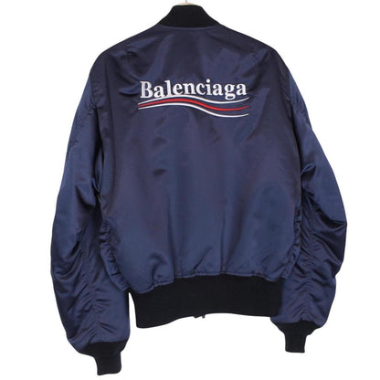 Balenciaga navy bomber jacket with full zip and campaign logo on chest.