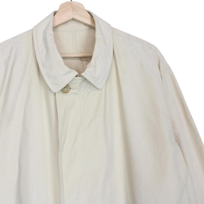 Burberry beige coat with classic check pattern and logo detail on collar.