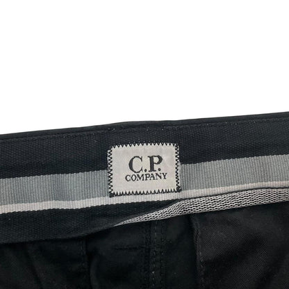 CP Company navy blue tapered fit cargo trousers with lens detail and pockets.