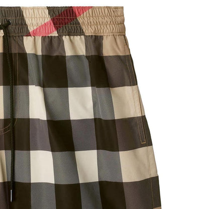 Burberry beige swim shorts featuring Nova Check pattern and nylon material.