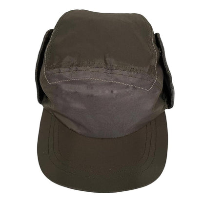 Paul Smith khaki green nylon ear-flap cap with logo detail and adjustable straps.