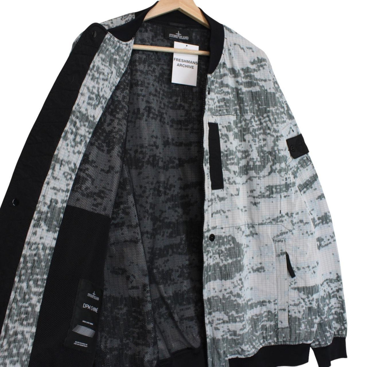 Stone Island bomber jacket grey marl with embroidered compass logo and unique pattern.