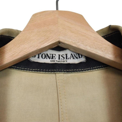 Stone Island beige multi-pocket jacket with logo patch and linen material.