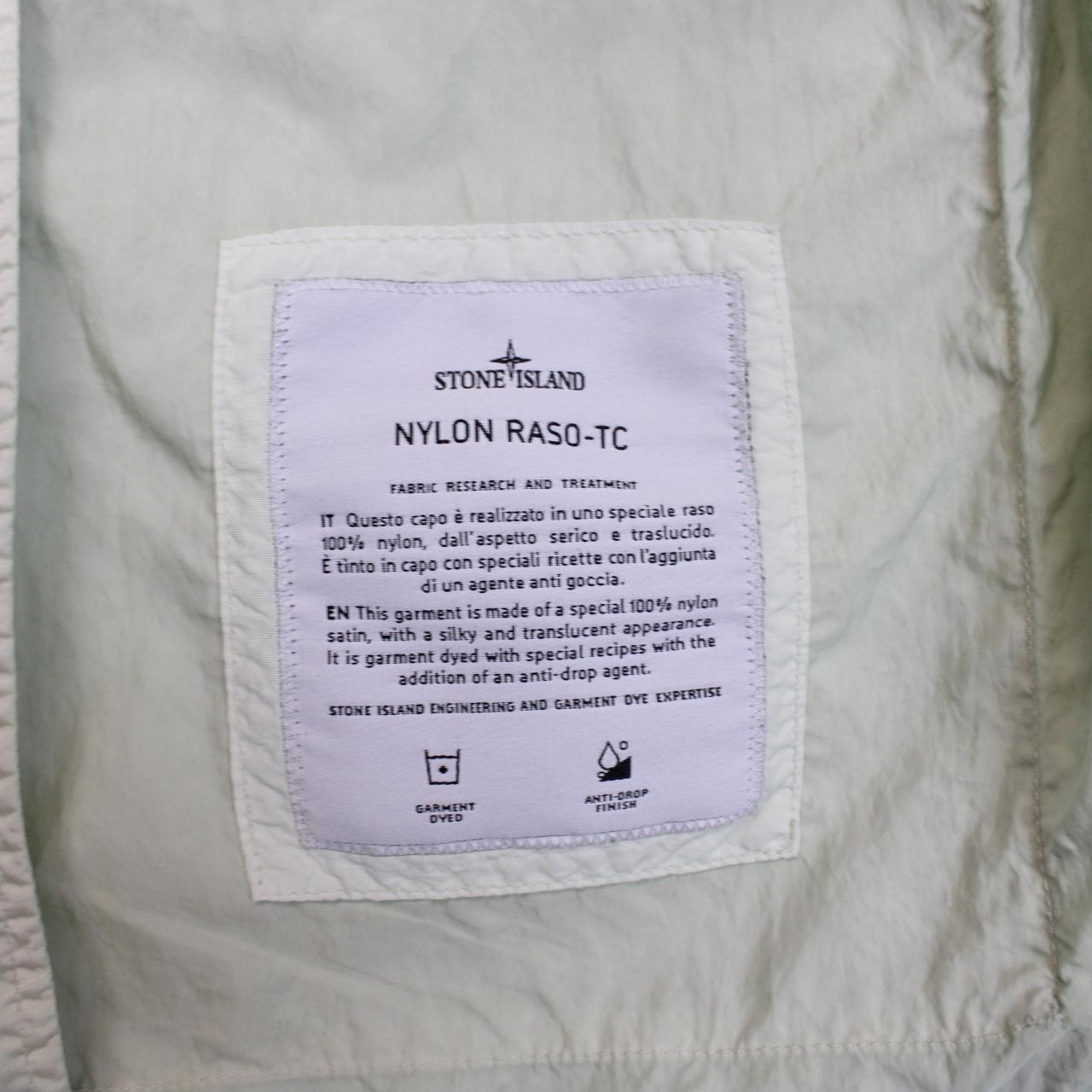 Stone Island mint green multi pocket jacket with logo patch and nylon material.