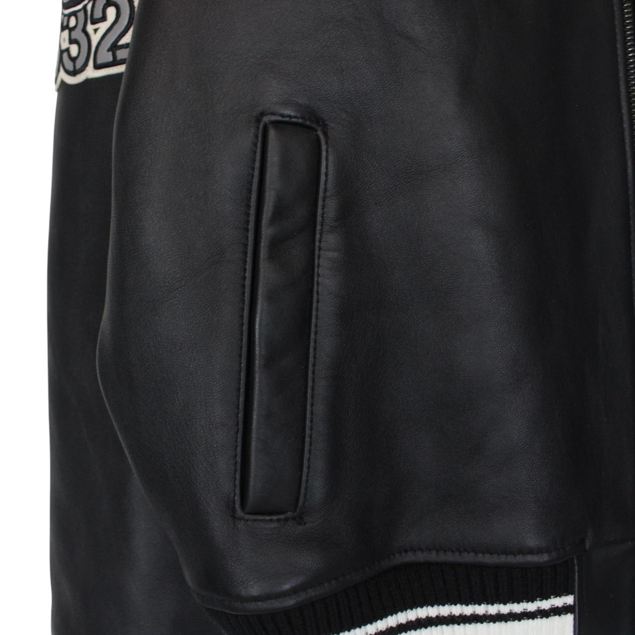 Avirex black leather jacket with Tuskegee Aces logo and full zip design.