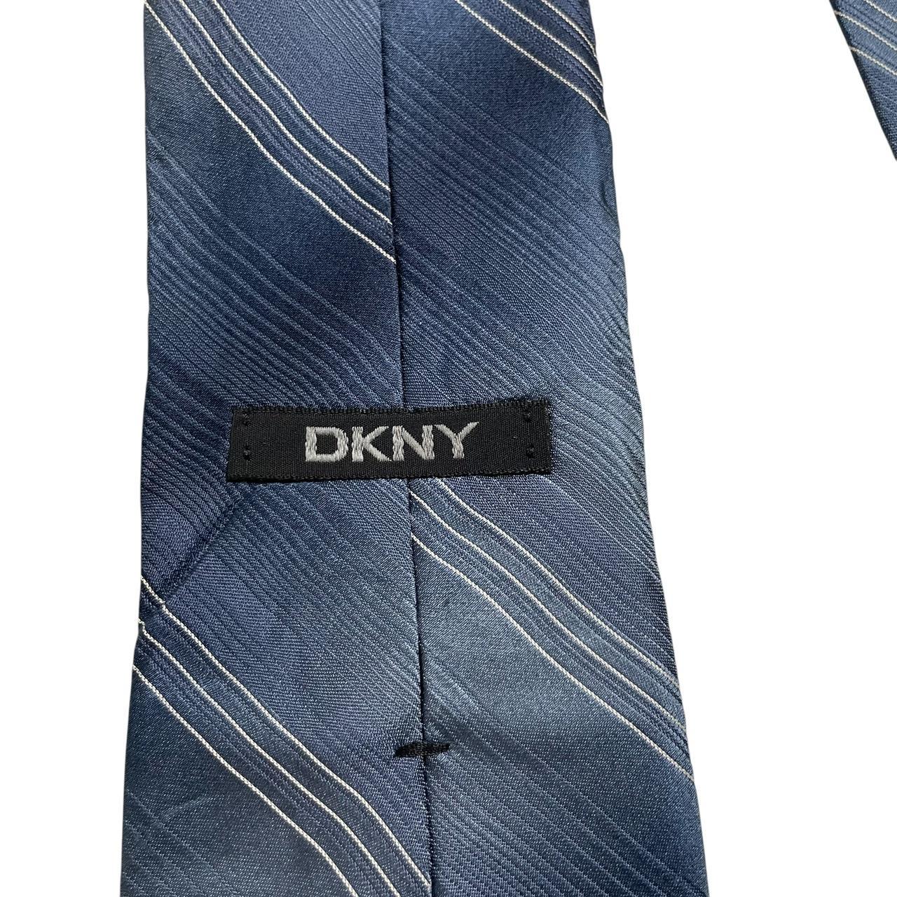 DKNY blue striped silk tie with elegant sheen and classic pattern.