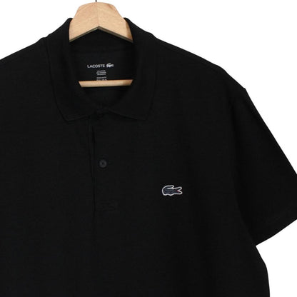 Lacoste black short sleeve polo shirt with embroidered crocodile logo, made of cotton.