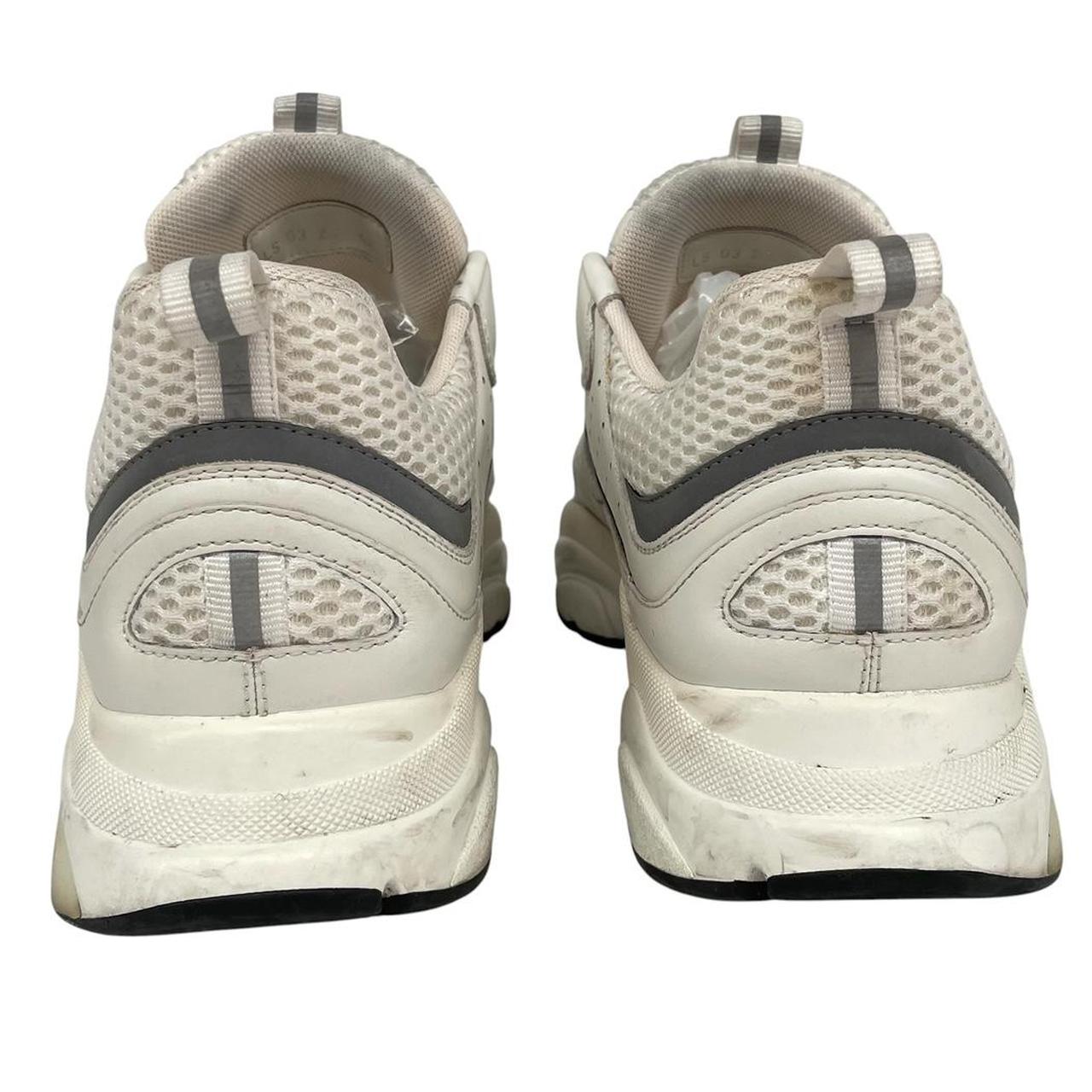 Dior grey and white trainers with logo detailing and worn soles.