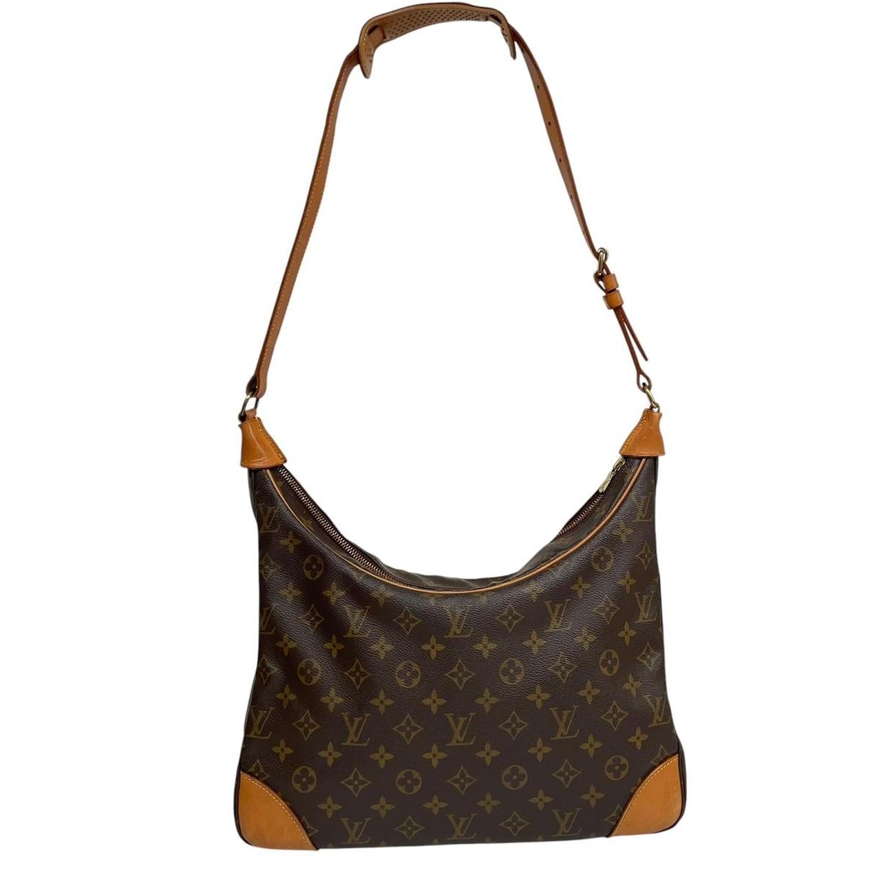 Louis Vuitton brown and tan monogram canvas duffel bag with leather accents and logo.