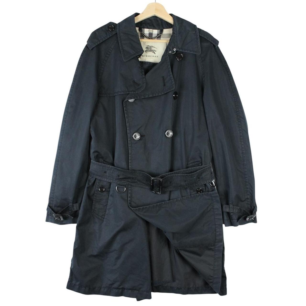 Burberry beige double breasted belted trench coat with classic check lining and logo detail.