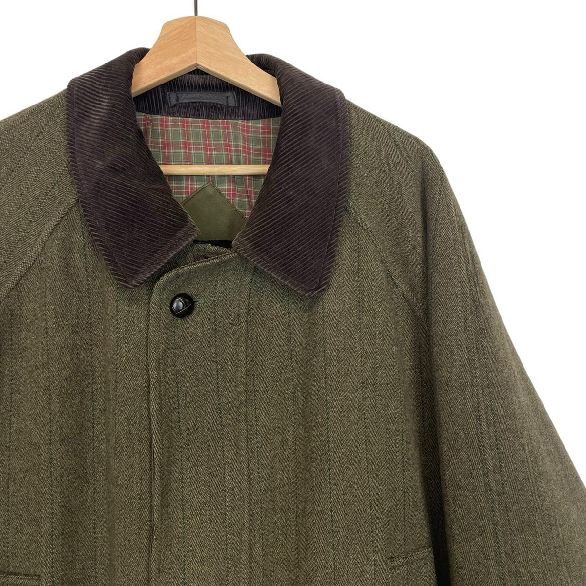 Barbour green tweed wool coat with classic pattern and missing front pocket button.