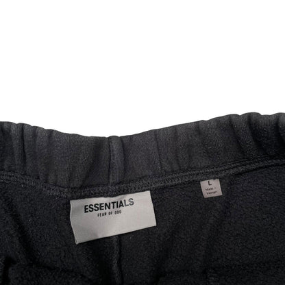Essentials black jogger shorts cotton material with faded detailing and logo.
