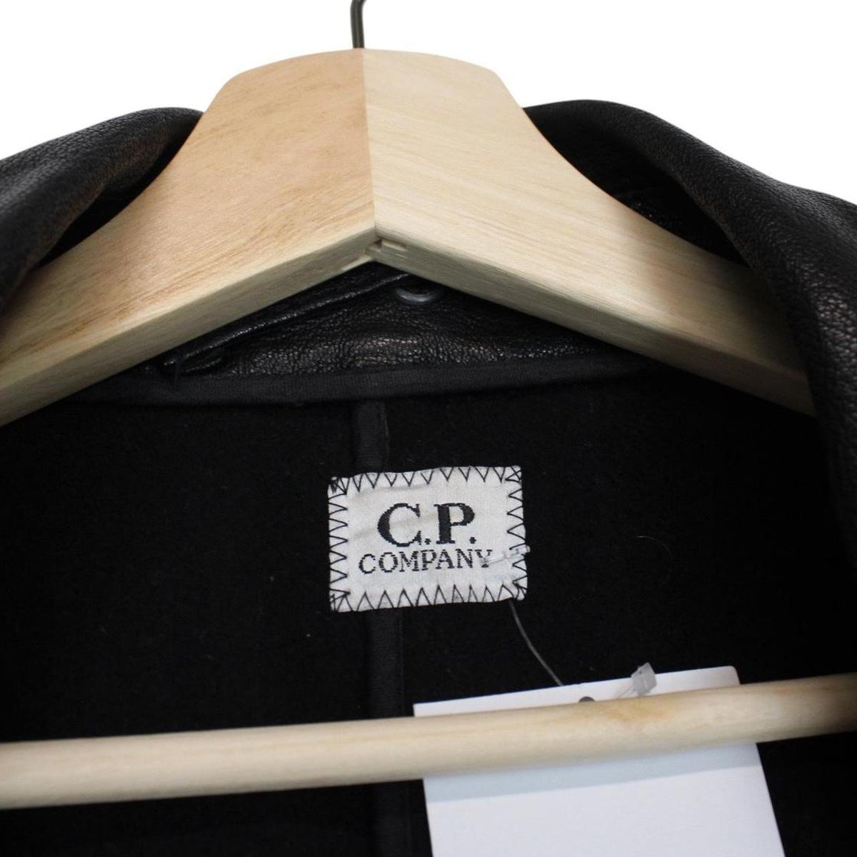 CP Company black leather jacket with multi pockets and logo detail.