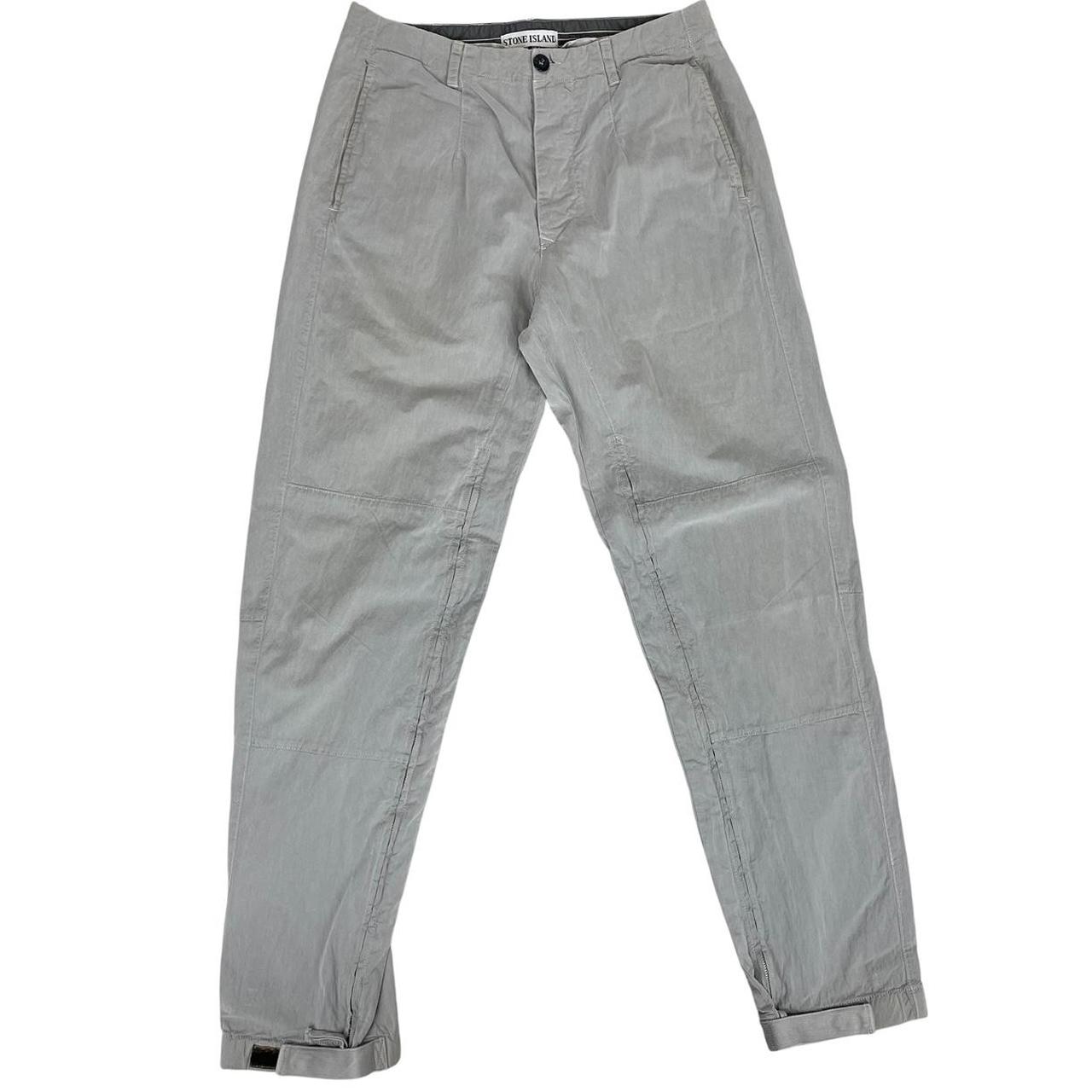 Stone Island grey tapered fit trousers with logo patch and cotton material.